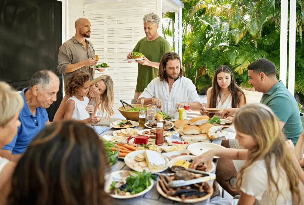Family enjoying a lively outdoor meal together.